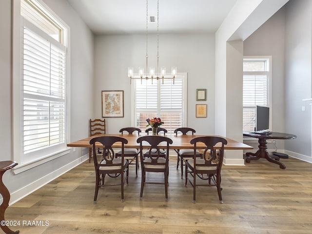 dining area featuring an inviting chandelier and hardwood / wood-style floors