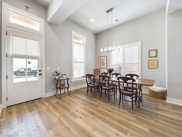 dining room featuring an inviting chandelier, light hardwood / wood-style flooring, and plenty of natural light