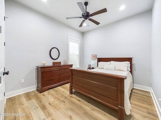 bedroom with light hardwood / wood-style floors and ceiling fan