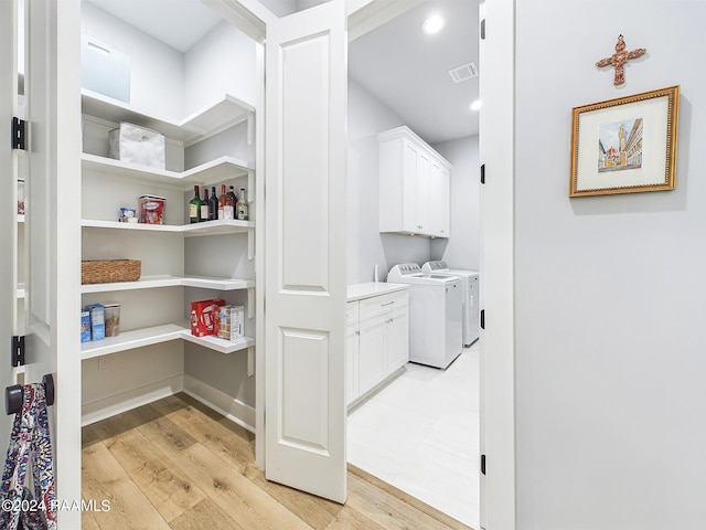 102 Blue Harbor Ln, Lafayette, LA 70503 - washroom featuring cabinet space, light wood finished floors, washing machine and clothes dryer, and recessed lighting