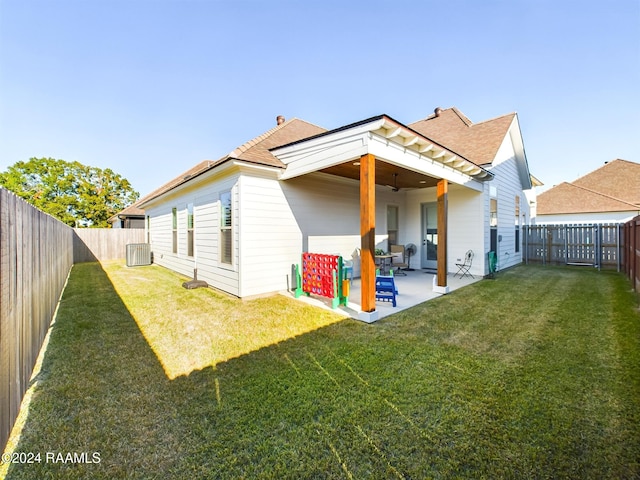 rear view of property with a patio area, a lawn, and ceiling fan