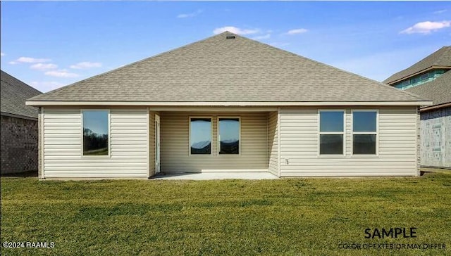 rear view of property featuring a patio area and a yard