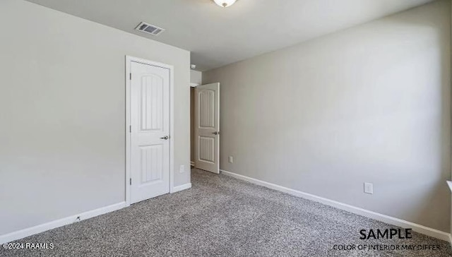 empty room featuring light carpet