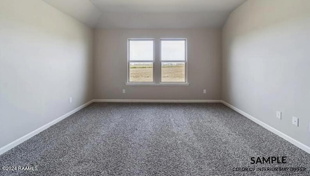 carpeted empty room featuring lofted ceiling