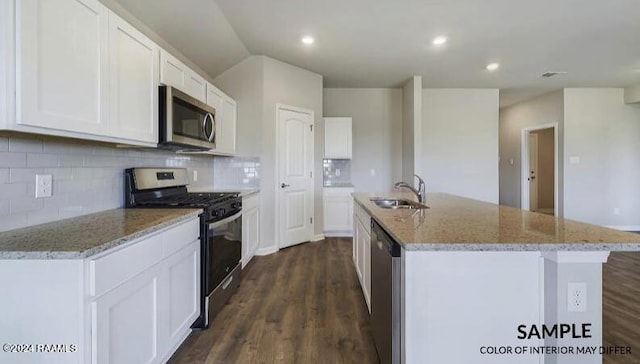 kitchen with white cabinetry, dark hardwood / wood-style flooring, an island with sink, and stainless steel appliances