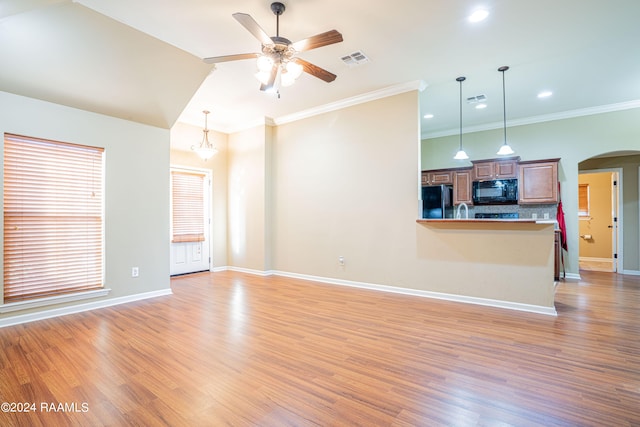 unfurnished living room featuring ceiling fan with notable chandelier, light hardwood / wood-style flooring, and ornamental molding