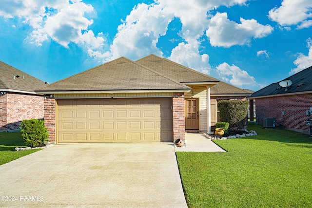 view of front facade featuring a front yard, a garage, and central AC unit