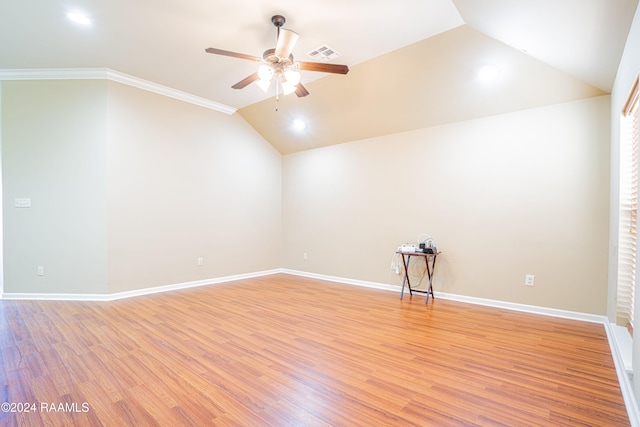 empty room with crown molding, ceiling fan, vaulted ceiling, and light hardwood / wood-style flooring