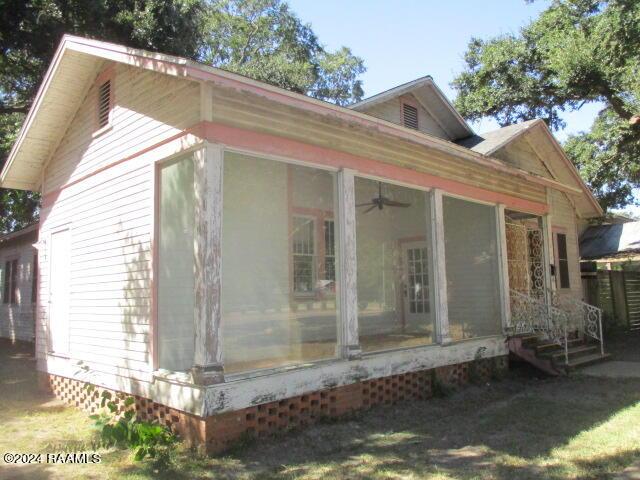 414 E Main St, Ville Platte, LA 70586 - view of side of home featuring a sunroom
