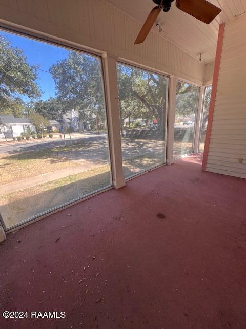 unfurnished sunroom featuring lofted ceiling and ceiling fan