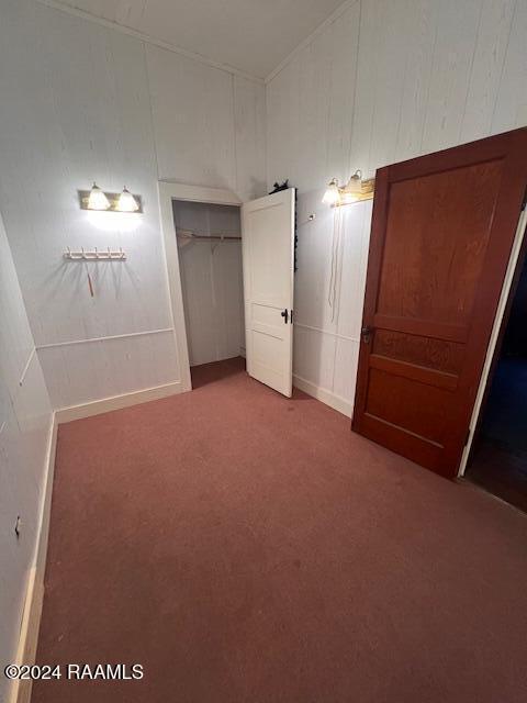 414 E Main St, Ville Platte, LA 70586 - unfurnished bedroom with a closet, carpet, and a decorative wall