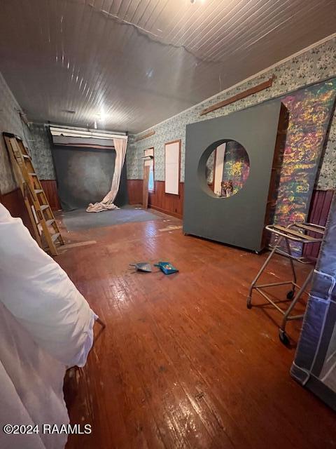 414 E Main St, Ville Platte, LA 70586 - interior space with wallpapered walls, a wainscoted wall, wooden walls, and hardwood / wood-style flooring