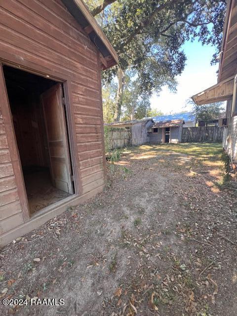 414 E Main St, Ville Platte, LA 70586 - view of yard with an outdoor structure, fence, and a shed