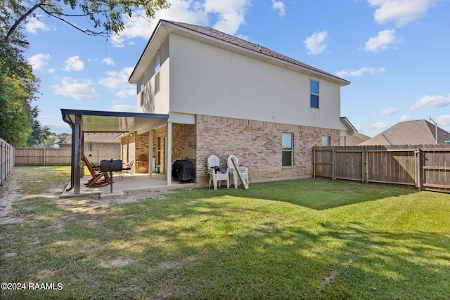 back of property with a patio and a lawn