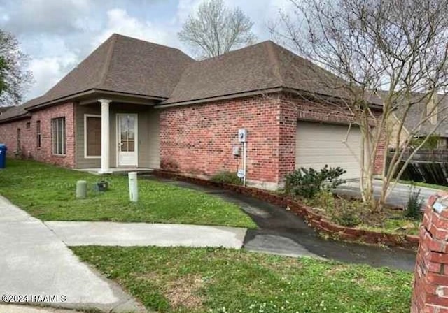 view of front of home with a garage and a front yard