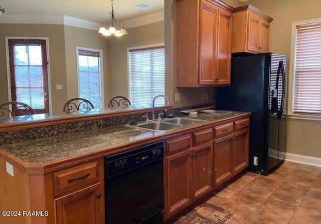 kitchen featuring plenty of natural light, sink, kitchen peninsula, and black appliances