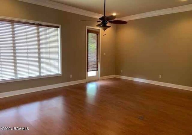 unfurnished room with wood-type flooring, ornamental molding, and ceiling fan