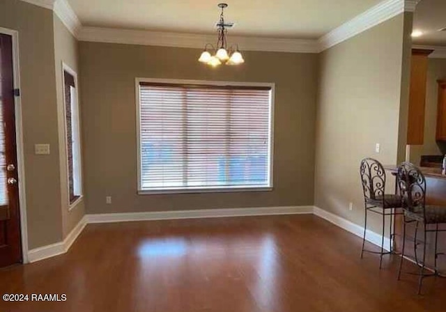 unfurnished dining area with a notable chandelier, crown molding, and dark hardwood / wood-style flooring