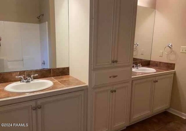 bathroom featuring walk in shower and vanity