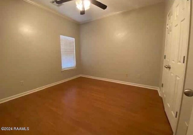 empty room with ceiling fan, crown molding, and dark hardwood / wood-style flooring