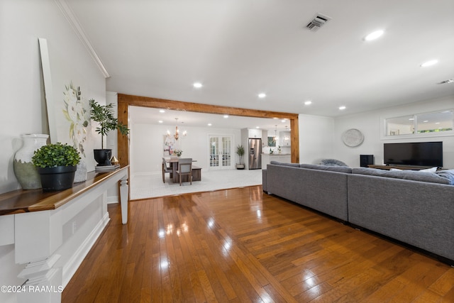 living room featuring hardwood / wood-style flooring and a chandelier