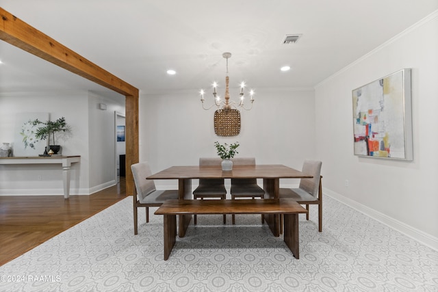 dining space featuring a chandelier and crown molding