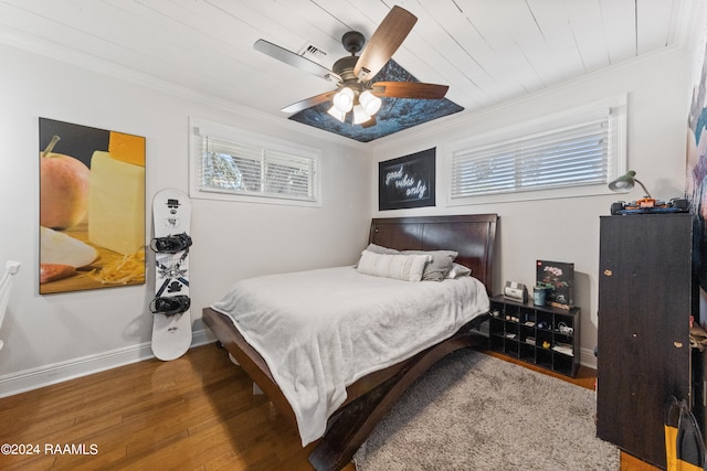 bedroom with hardwood / wood-style flooring, ceiling fan, crown molding, and wood ceiling