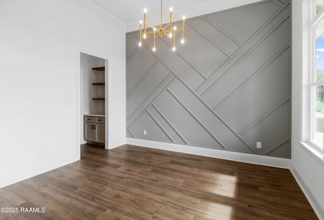 spare room with an inviting chandelier and dark hardwood / wood-style floors