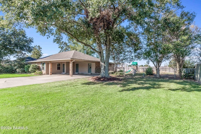 view of front of house with a playground and a front yard