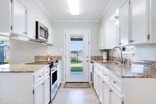 kitchen featuring light stone countertops, white cabinetry, electric range, and sink