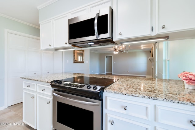 kitchen with crown molding, light tile patterned flooring, stainless steel appliances, and white cabinets