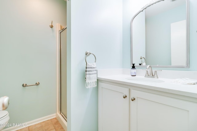 bathroom featuring vanity, toilet, an enclosed shower, and tile patterned floors