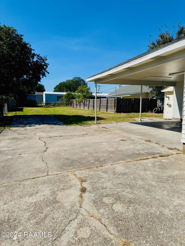 205 Gauraud St, Abbeville, LA 70510 - view of parking with driveway and a carport