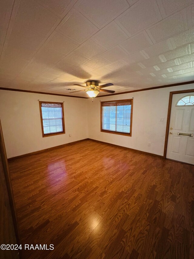 205 Gauraud St, Abbeville, LA 70510 - spare room with wood finished floors, crown molding, ceiling fan, and baseboards