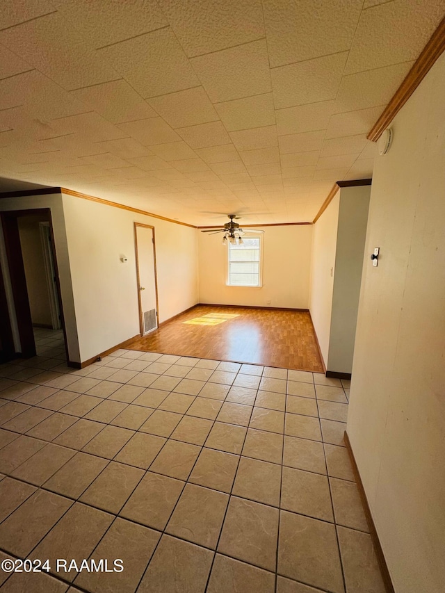 205 Gauraud St, Abbeville, LA 70510 - empty room with light tile patterned flooring, ornamental molding, baseboards, and a ceiling fan