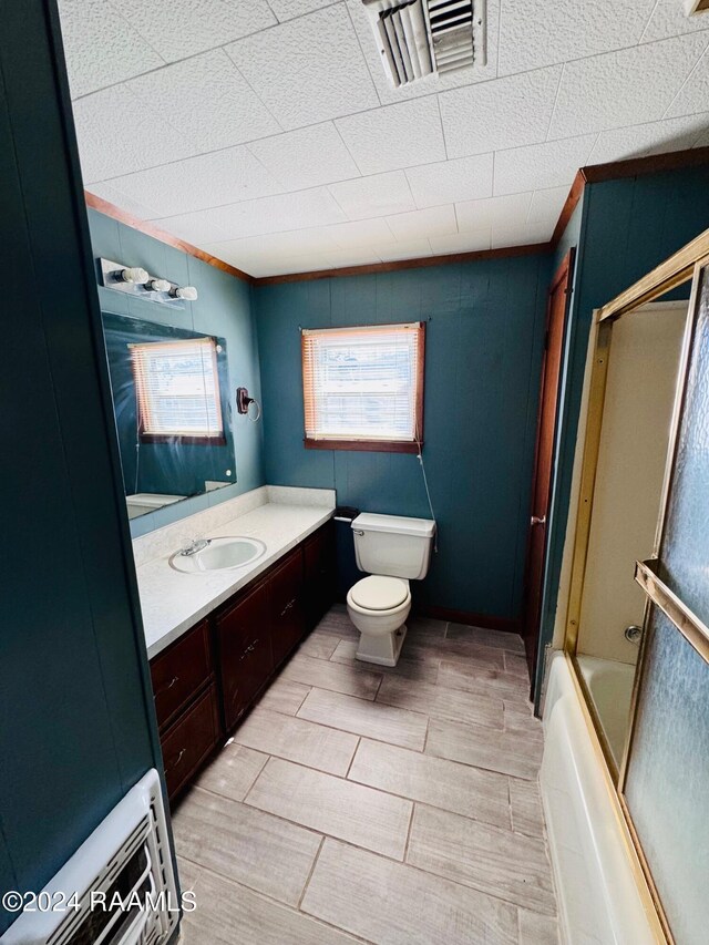 205 Gauraud St, Abbeville, LA 70510 - full bathroom with toilet, vanity, enclosed tub / shower combo, and ornamental molding