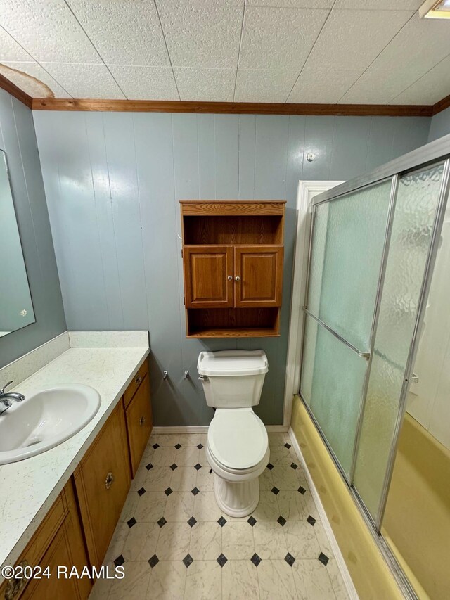 205 Gauraud St, Abbeville, LA 70510 - full bath with ornamental molding, vanity, shower / bath combination with glass door, toilet, and tile patterned floors