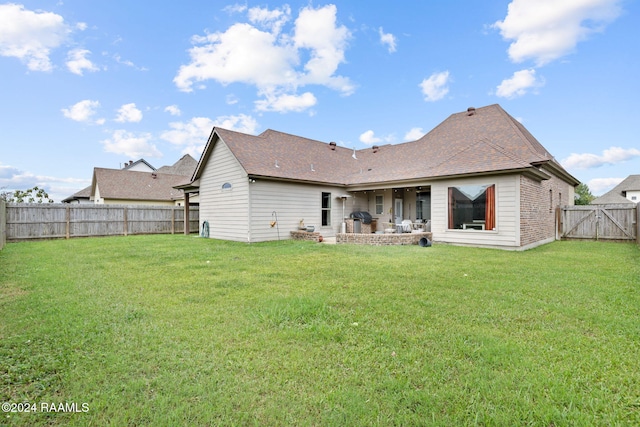 rear view of property with a patio area and a yard