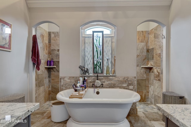 bathroom featuring ornamental molding, tile walls, vanity, and a bath