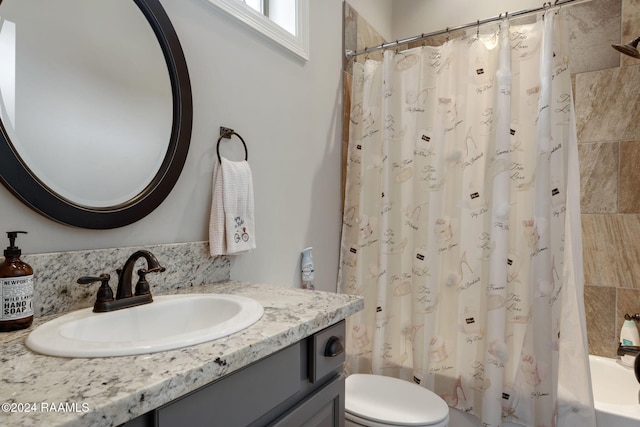 full bathroom featuring vanity, shower / bath combo, and toilet