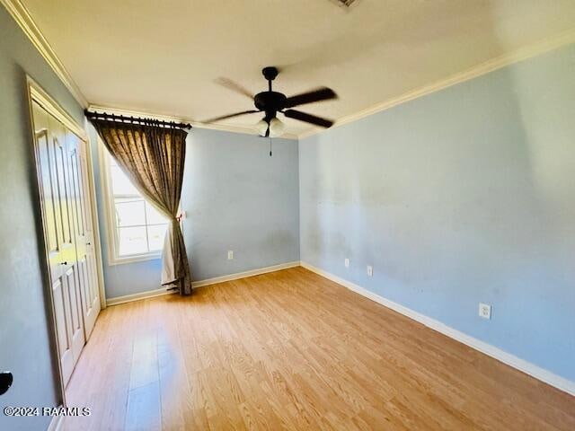 spare room featuring crown molding, ceiling fan, and light hardwood / wood-style floors