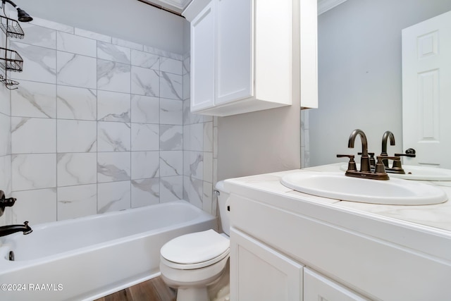 full bathroom featuring hardwood / wood-style floors, vanity, toilet, and tiled shower / bath