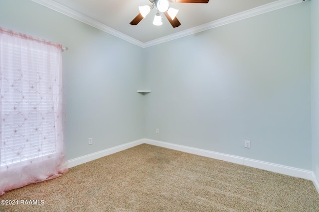 carpeted spare room featuring ceiling fan and ornamental molding