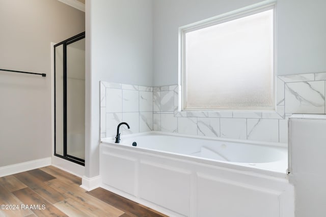 bathroom featuring wood-type flooring and independent shower and bath