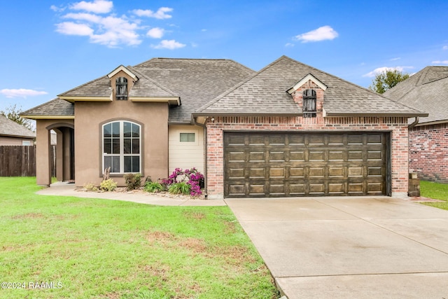 view of front of property with a garage and a front yard