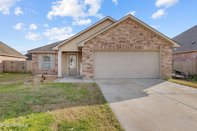 view of front of house with a garage and a front lawn