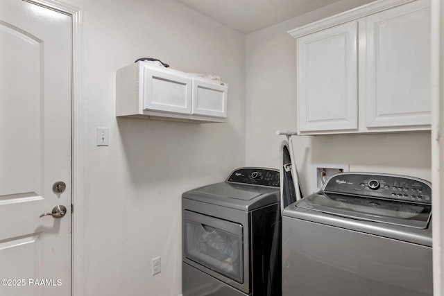 laundry area featuring cabinets and washing machine and dryer