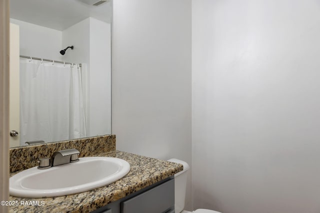 bathroom with vanity and toilet