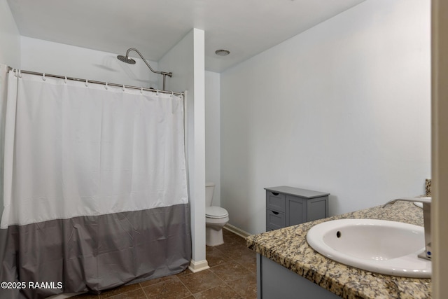 bathroom featuring vanity, toilet, and walk in shower