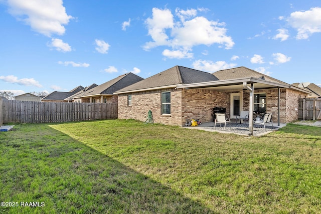 rear view of property featuring a yard and a patio area